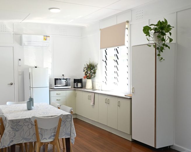 A cabin with a microwave and coffee maker sit on the counter.