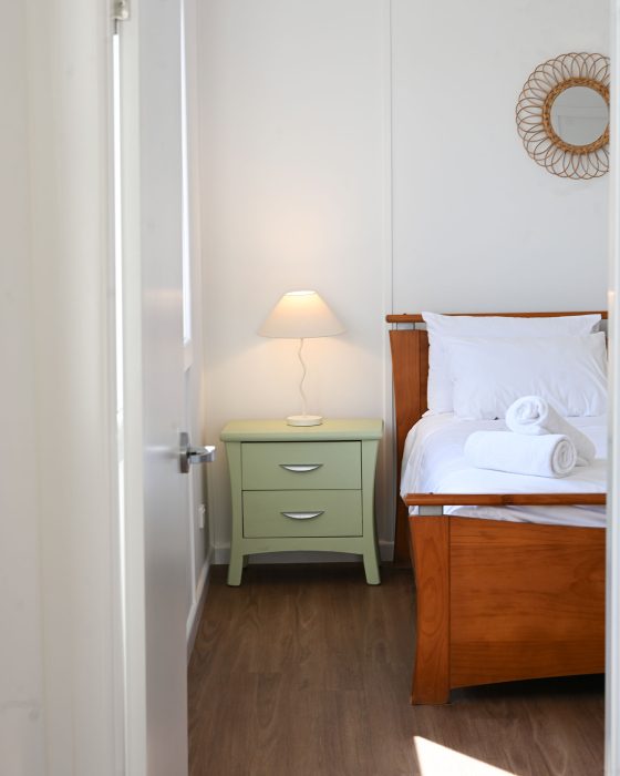 The walls are white, and the floor is a warm wood-look laminate.